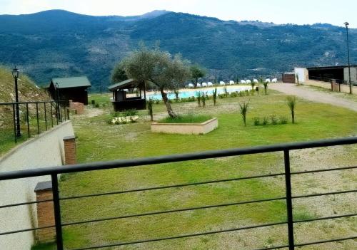 a view from a balcony of a park with a tree at Nebrodi Agrivillage Bianca Sole Mia in Alcara li Fusi