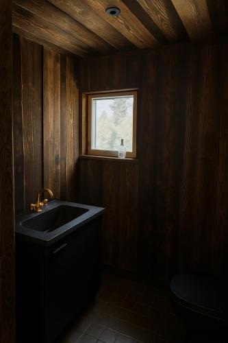 a bathroom with a sink and a window at Arctic Shaman Adventures -Jurtta in Köngäs