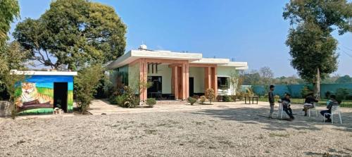 a group of people standing in front of a building at Anha Farmstay in Mādho Tānda