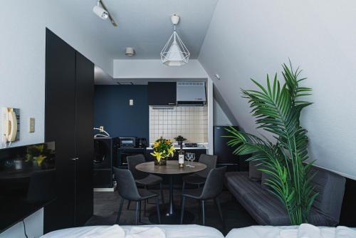 a living room with a table and chairs and a kitchen at SLL Urban Suites Akasaka in Tokyo