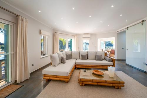 a living room with a couch and a table at Villa Luso w/ Heated Pool - Spacious & Peaceful in Moncarapacho