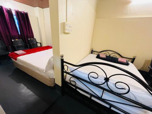 a bedroom with two beds in a room at Siilver Sands Hutt Homestay - Malpe Beach in Malpe