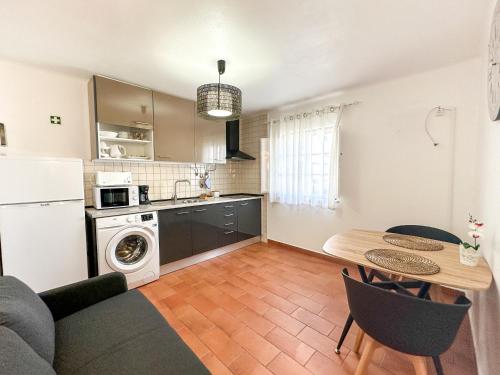 a living room with a kitchen and a dining room table at Casa da Alagoinha by Umbral in Vila Nova de Milfontes