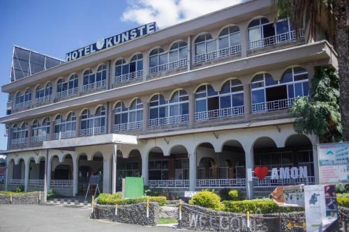 a building with a sign on top of it at Stylish Studio Retreat- Inside Kunste Hotel in Nakuru