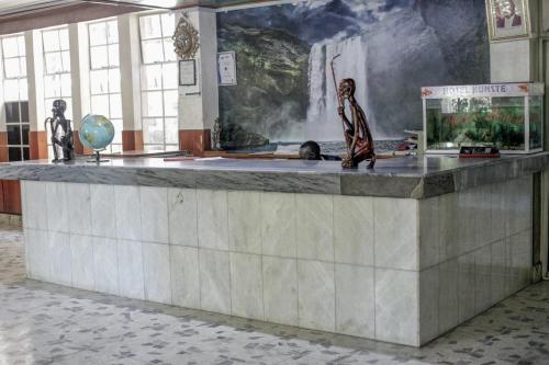 a lobby with a large painting of a waterfall at Stylish Studio Retreat- Inside Kunste Hotel in Nakuru