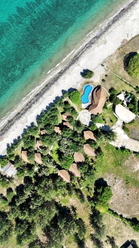 an aerial view of a house next to the ocean at Tanoma Sumba in Maujawa