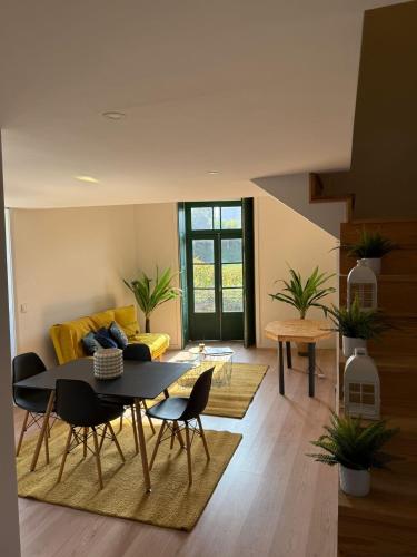 a living room with a table and a yellow couch at Douro Villa 2 -Best View in Town in Vila Nova de Gaia