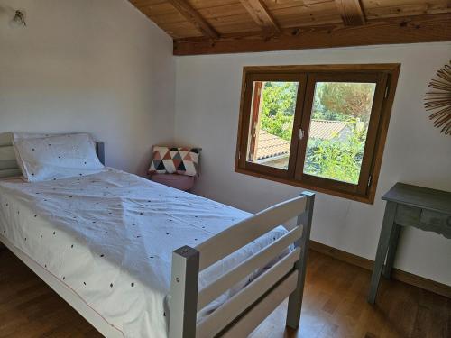 a bedroom with a bed and a window at Maison 5 chambres à Dieulefit in Dieulefit