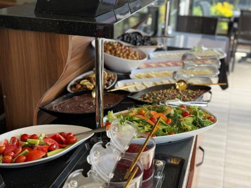 a buffet line with many plates of food on it at HİSAR HOTEL in Istanbul