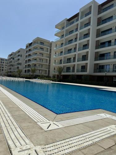a large swimming pool in front of a building at sea breeze park residences in Mekhrably