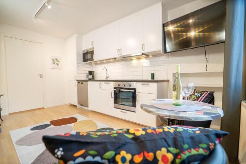 a kitchen with a couch and a table in a room at Haga Studio, Super Location with Full Comfort in Gothenburg