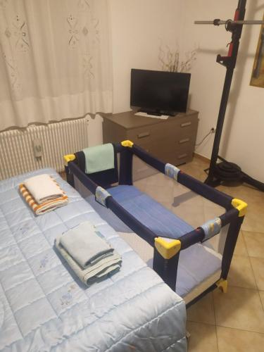 a bedroom with a bed with a swing at Da Matte e Ale - Tolmezzo in Tolmezzo