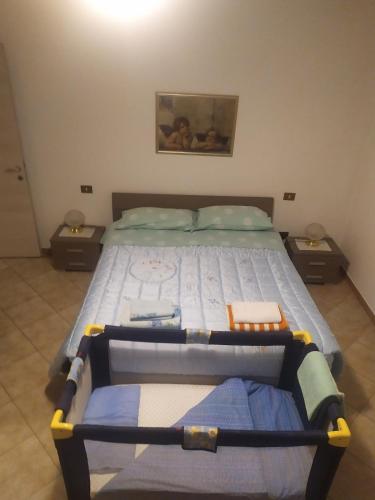a bedroom with a large bed with two night stands at Da Matte e Ale - Tolmezzo in Tolmezzo