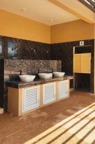 a bathroom with three sinks on a counter at Condo in Lapu Lapu near AirportFree wifiParking in Agus