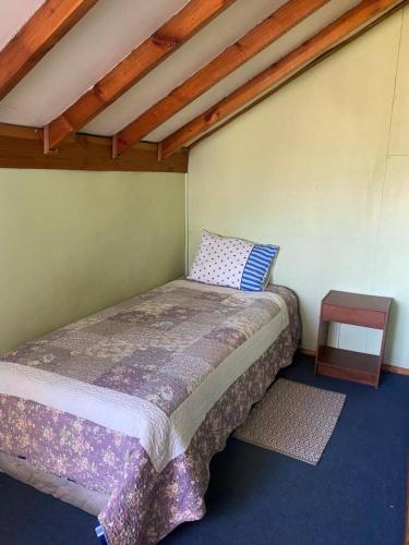 a bedroom with a bed in a room at Cabañas Casa Blanca in Valdivia