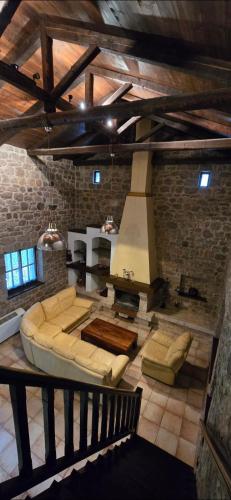 a large living room with a couch and a stove at Panos Stone House in Lílaia