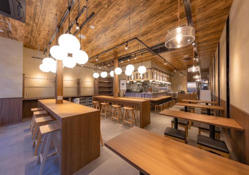 a restaurant with wooden ceilings and wooden tables and chairs at APA Hotel Morioka Ekimae in Morioka