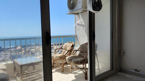 a balcony with a view of the city at شقه على البحر مباشره فى عمارات الظباط مصطفى كامل سيتي اسكوير in Alexandria