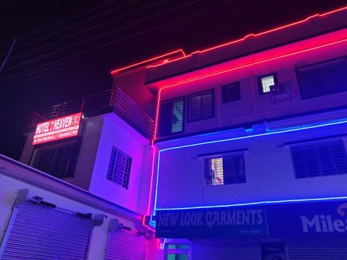 a building with red and purple lights on it at Hotel Seven Heaven in mayapur