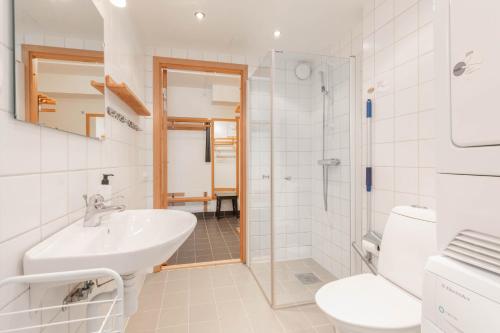a white bathroom with a sink and a shower at Åre Travel - Åre Parken 18 in Åre
