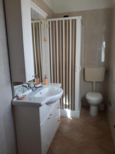 a bathroom with a sink and a toilet at B&B LA COLLINA in Pietrelcina