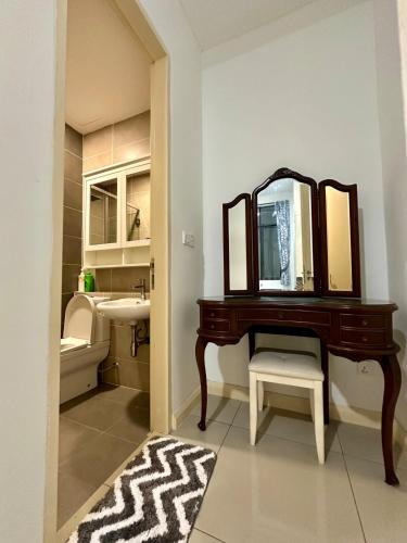 a bathroom with a vanity with a mirror and a sink at D'pristine 4 bedroom condo 1725 opposite Legoland and Medini mall in Iskandar Puteri