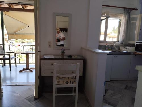 a kitchen with a table and a chair in a room at Grivas Apartments in Sivota