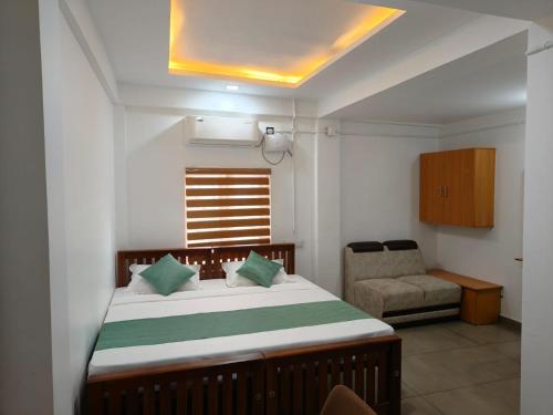 a bedroom with a bed with a chair and a window at Skyline Inn in Anachal