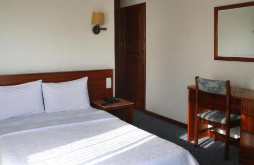 Un ou plusieurs lits dans un hébergement de l'établissement Hotel Aeroporto