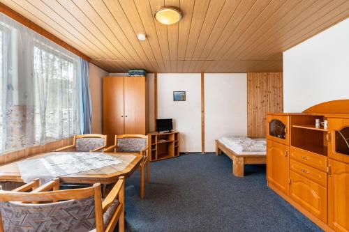a room with a table and chairs and a bed at Bungalow 20 - Kimbucht in Reichendorf