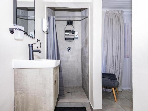 a bathroom with a sink and a shower at Urban Oaks in Bellville