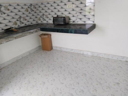 a room with a counter with a phone on the wall at Omkar Homestay in Prayagraj