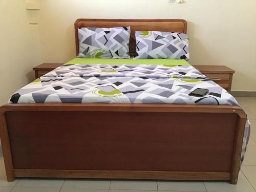 Ένα ή περισσότερα κρεβάτια σε δωμάτιο στο NOOMA PRESTIGE OUAGa 2000