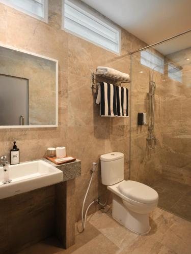 a bathroom with a toilet and a sink and a shower at Batumera in Pulau Payung Besar