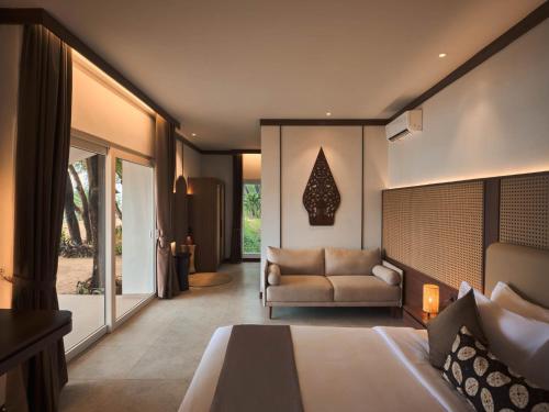 a hotel room with a bed and a couch at Batumera 