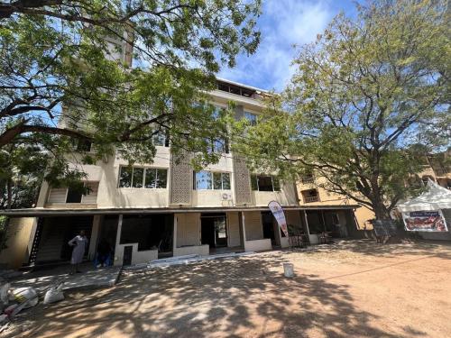 a building with people standing in front of it at holm's home studio in Diani Beach