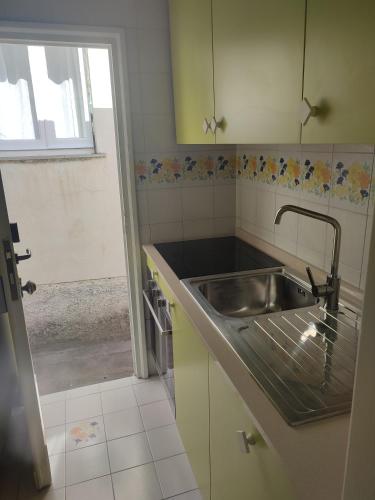 a kitchen with a stainless steel sink and a window at La Flavia in Capri