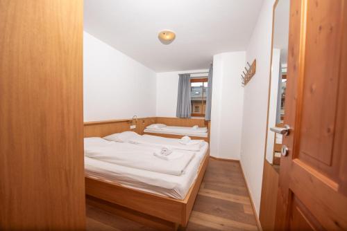 a small room with two beds and a door at Duxeranger C Top 8 in Krimml