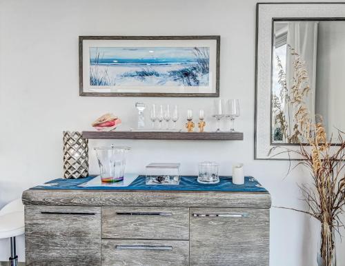 a room with a dresser with glasses on it at Ocean View Modern in Tybee Island