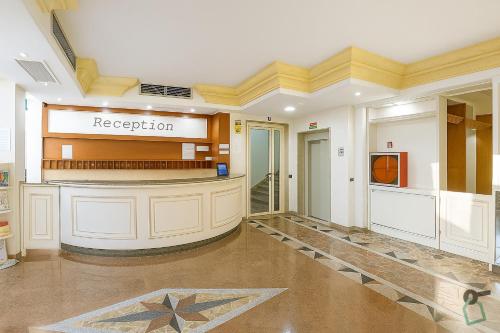 a lobby of a hospital with a reception area at Hotiday Porto Cesareo in Porto Cesareo