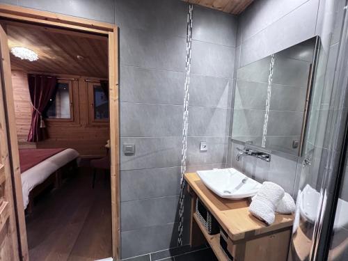 a bathroom with a sink and a mirror at Chalet Virolet in Les Gets