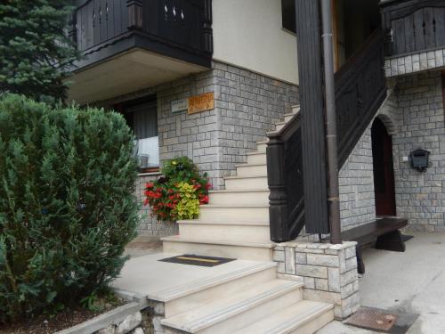 a set of stairs to a house with a balcony at Apartment Dijak in Bohinj