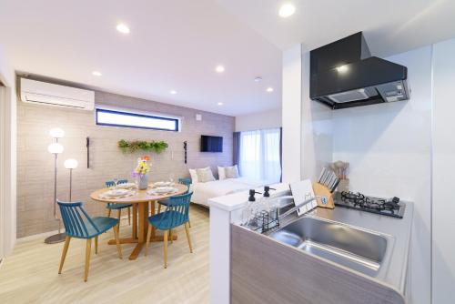 a kitchen and living room with a table and a sink at Nagoya Cozy Base in Nagoya