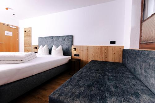 a hotel room with two beds and a window at Gasthof Aigner *** in Fügen