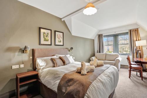 a bedroom with a bed and a couch and a chair at The Lambton in Durham