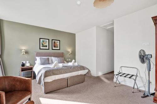 a bedroom with a bed and a chair at The Lambton in Durham