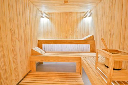 a sauna with wooden walls and wooden shelves at A pasos del Shopping del Sol in Asuncion