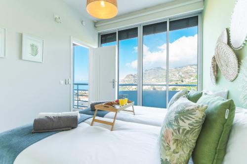 a bedroom with a bed with a view of the ocean at Pitanga by Atlantic Holiday in Panasqueira