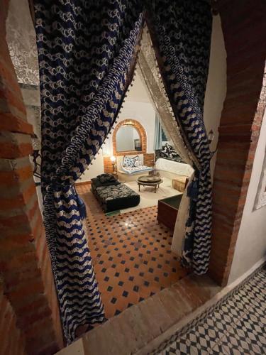 a view of a living room with a couch and a window at Dar fenan Lina in Chefchaouen