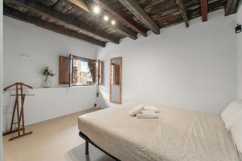 a bedroom with a bed with two towels on it at La Generosa in Arona